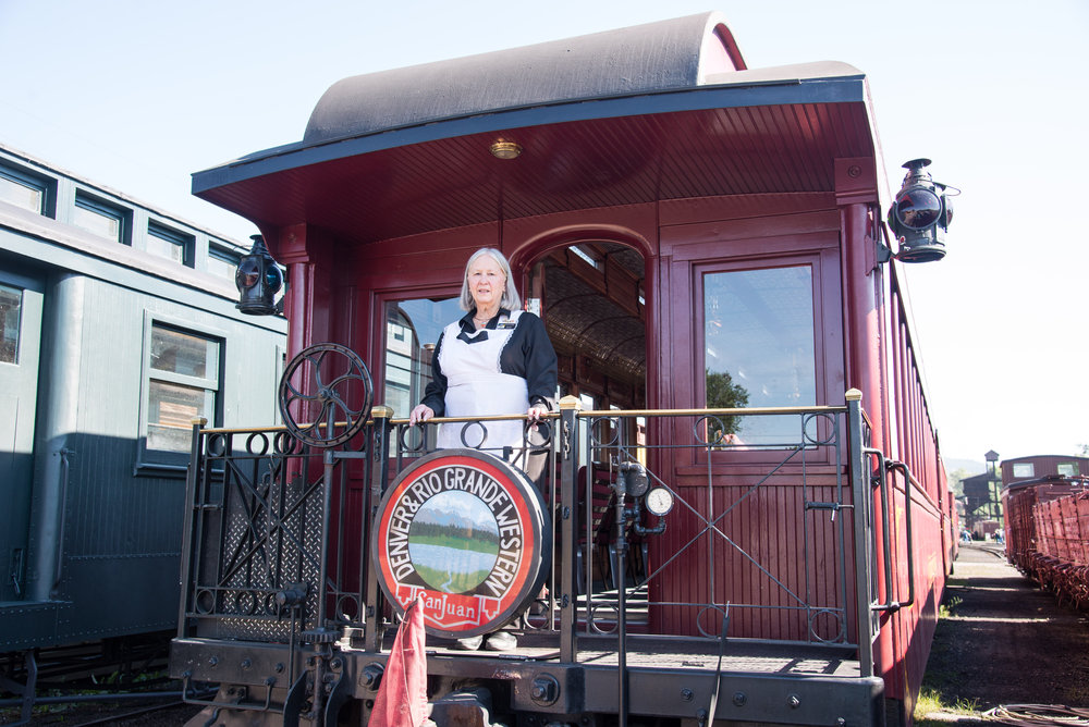 4 Parlor host Lorraine stands on the platform waiting for her passengers to load.jpg
