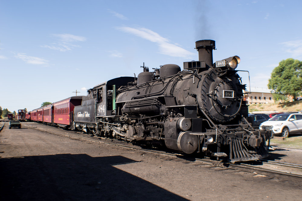 1 K37 484 sits at the head of train 216 as it waits to depart Chama.jpg