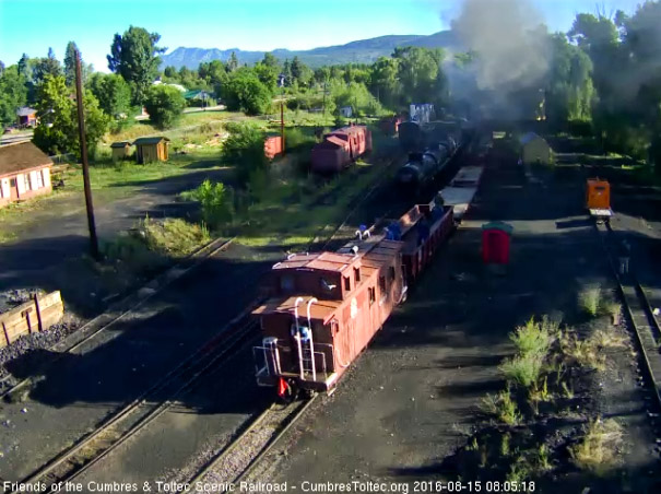 8.15.16 The conductor is standing on the platfom of the caboose.jpg