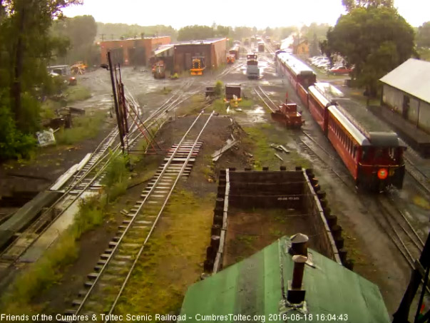 8.18.16 On the platform of the New Mexico only the trainman braves the rain.jpg