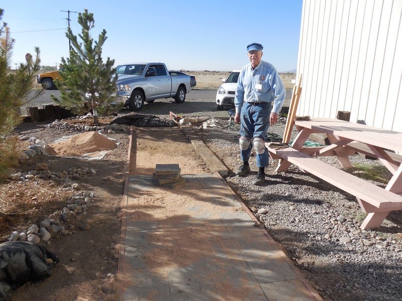 Jim Sublett wears his knee pads to continue installing sidewalk pavers at CRF.jpg