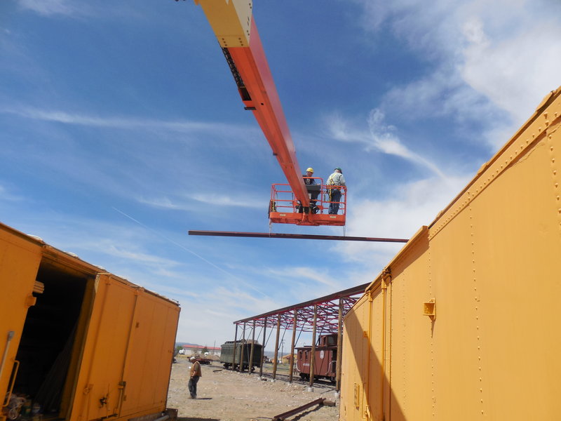 Russ Hanscom and Sam Hauck guide purlin to Car Shelter rooftop.JPG