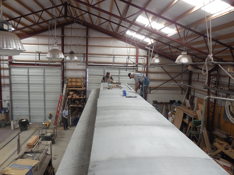 Cook Car 053 Team Leader Craig McMullen and Jack Heiermann put finishing touches on metal roof covering.jpg