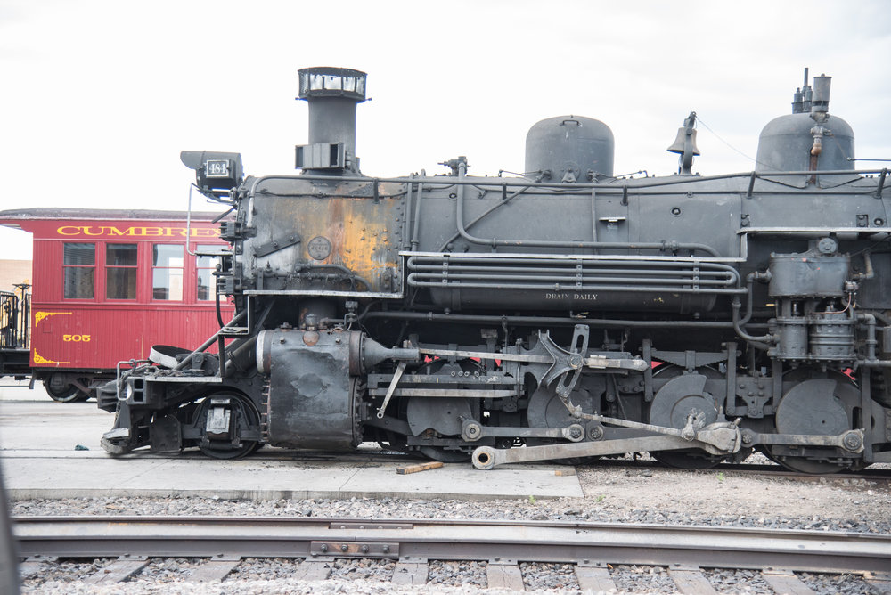 K36 484 sits in front of the Antonito engine house with its engineer side ciylinder in pieces.jpg