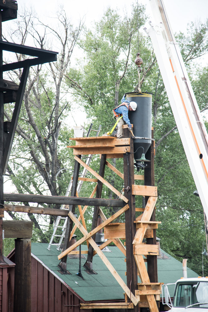 7-31-17 The crew on the tower is starting to tighten the bands that will stablize the tank.jpg