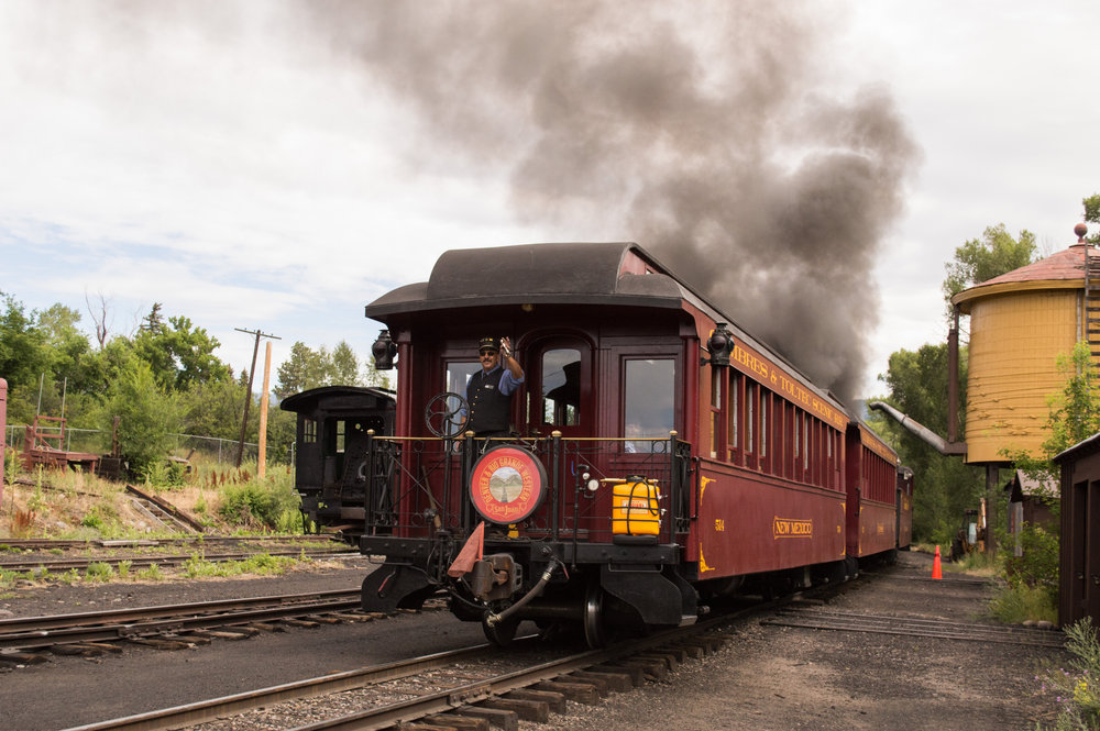 6 Conductor Ray gives a wave as the parlor New Mexico passes.jpg