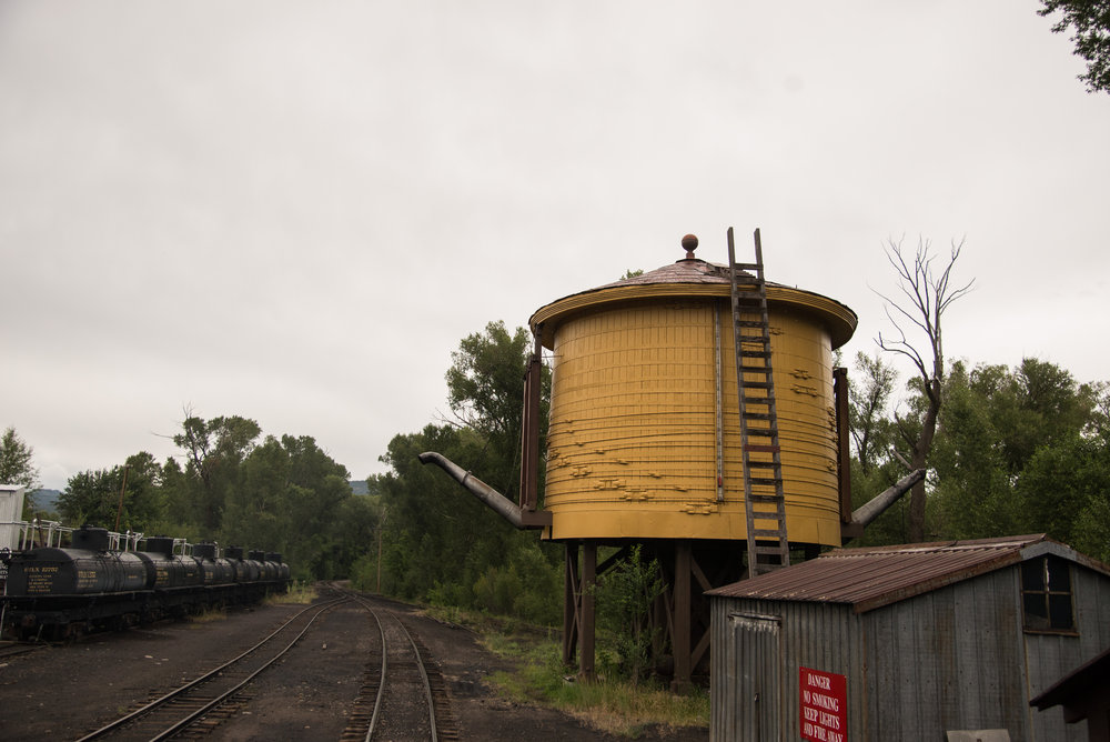 52 Entering Chama yard with the Gramps oil rack on the left and the water tank on the right.jpg