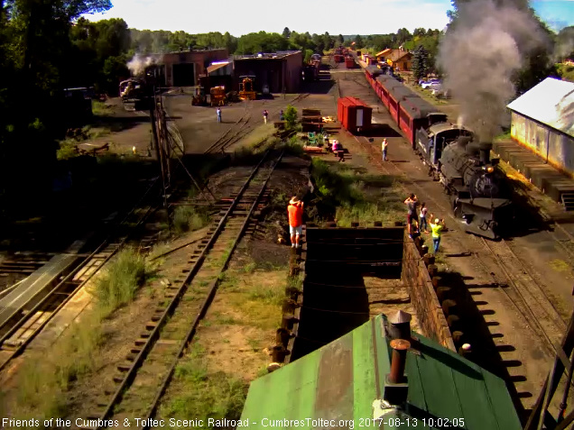 8-13-17 The train passes the wood shop with people waving.jpg