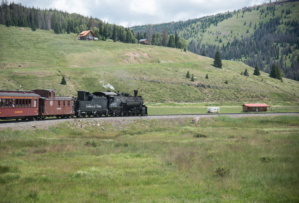 19 487 Rounds the horseshoe curve at the head of Los Pinos valley with the off grid homes.jpg