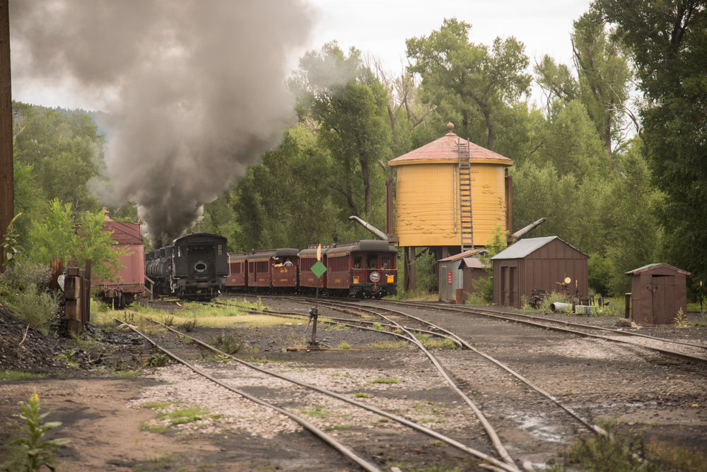 20 As the train passes the water tank, Cinder Bear is still in the open gon.jpg