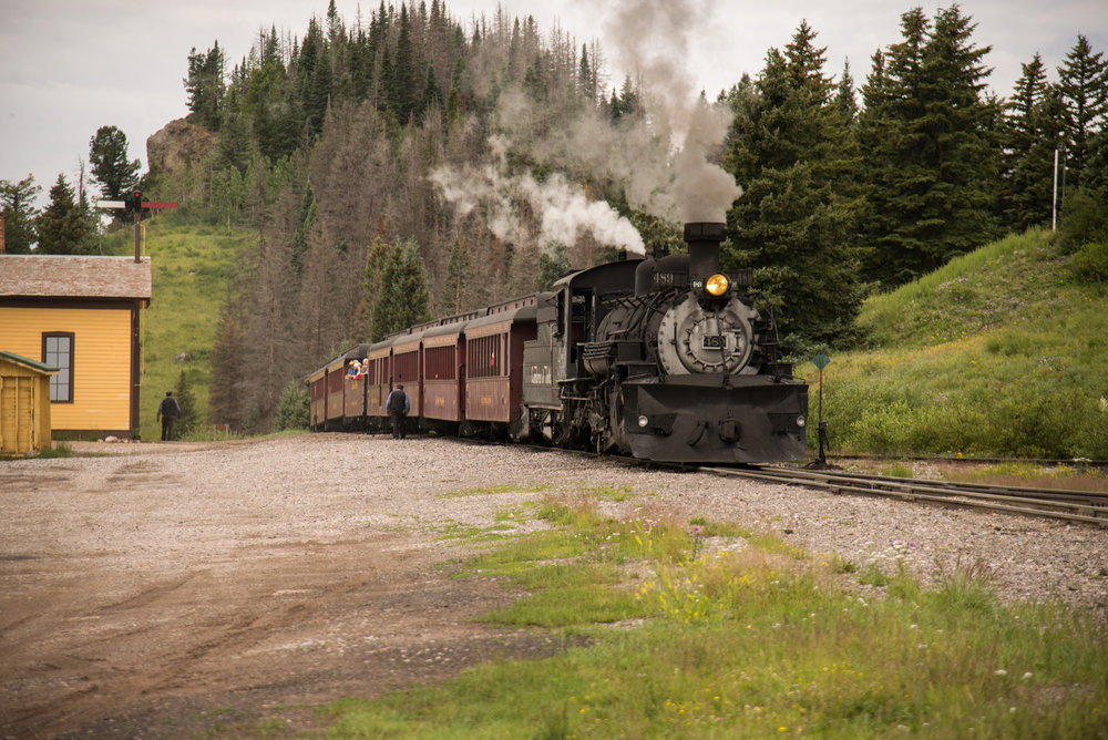 28 The trainman walks the train to check the brakes while its stopped at Cumbres for water.jpg