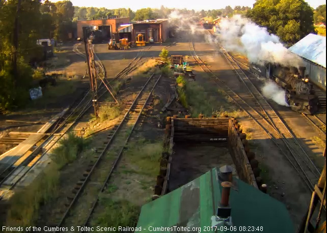 9-6-17 Nice steam on this cool morning in Chama, as 498 pulls past the wood shop.jpg