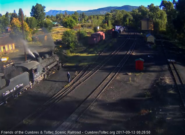 9-13-17 As one of the hostlers watches the loader adds coal to the bunker of 487's tender.jpg