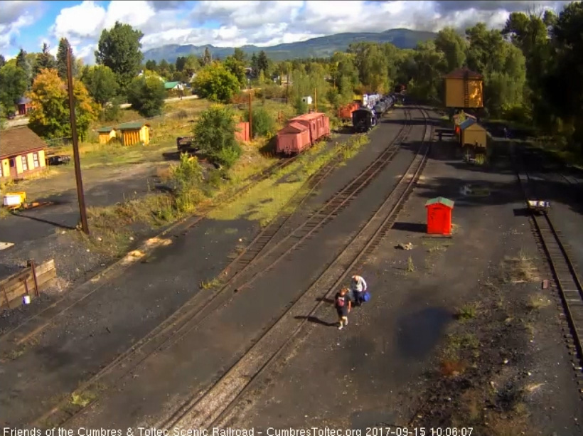 9-15-17 The last cars clear the yard and round the curve as people who have watched the train depart walk back.jpg