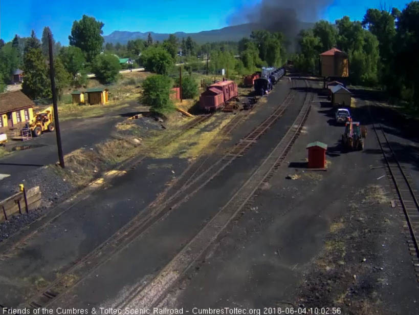 2018-06-04 The parlor is rounding the curve north of the yard while the loader has ties for the work going on.jpg