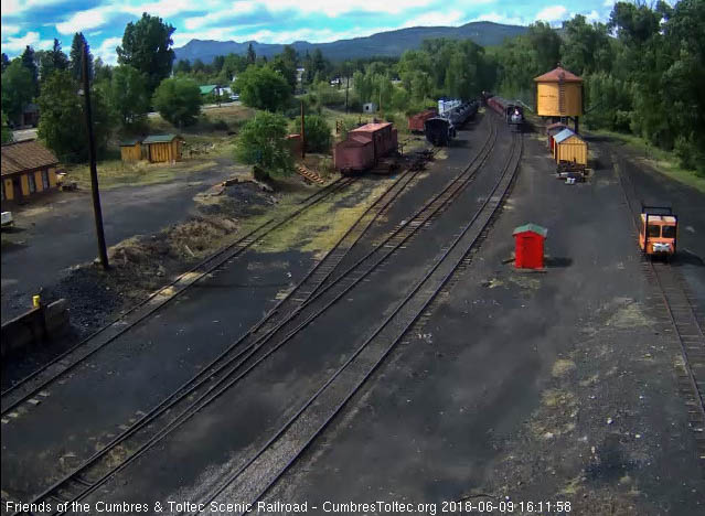 2018-06-09 487  comes up to the tank with its train as the speeder's light is seen behind.jpg