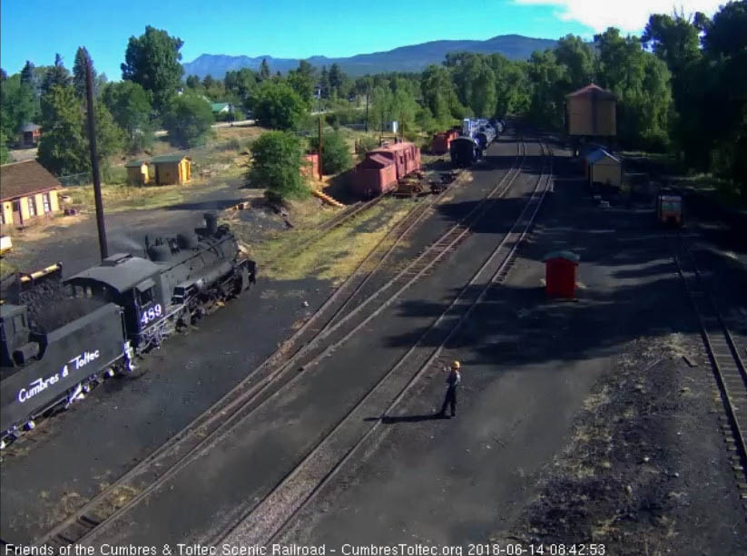 2018-06-14 One of the hostlers stands at a safe distance as the loader dumps in a bucket of coal.jpg