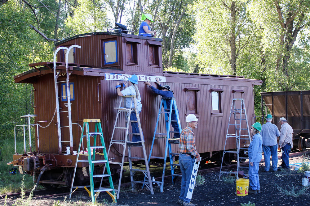2018-06-20 Overall shot of the caboose being worked on in the swamp.jpg