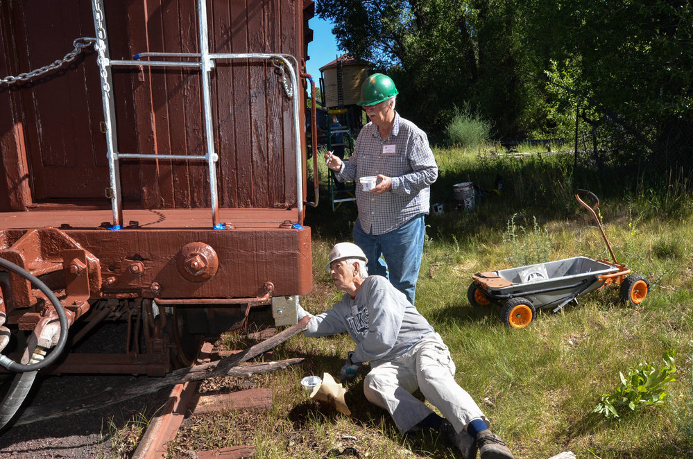 2018-06-20 The paint crew touches up a caboose in the swamp.jpg