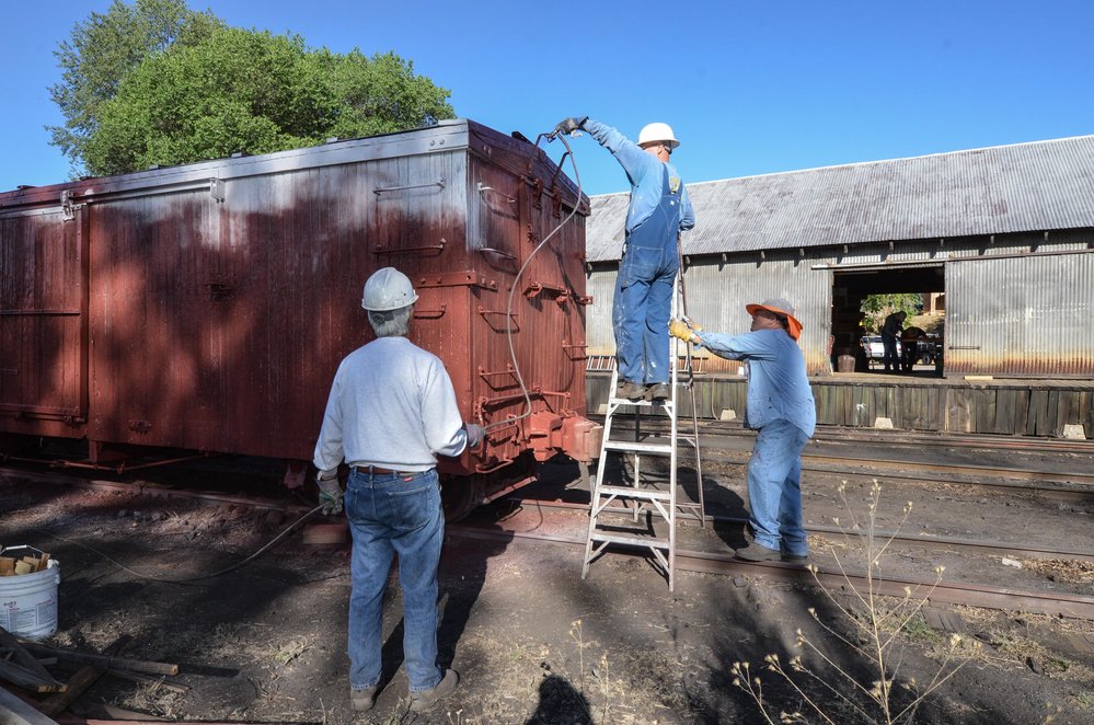 2018-06-29 The paint crew is spraying box car 3090 with box car red.jpg