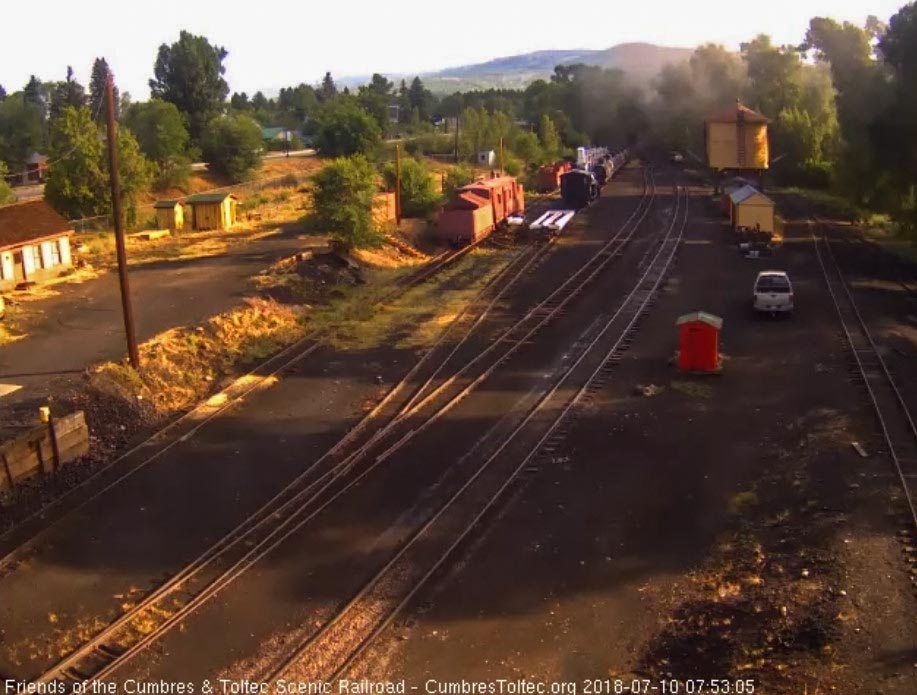 2018-07-10 The speeder with the water trailer is headed onto the main as the train rounds the curve.jpg