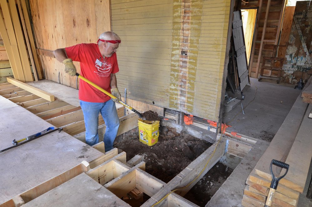 2018-07-24 The old fire brick is gone and the crew working on the fire place digs out a new base.jpg