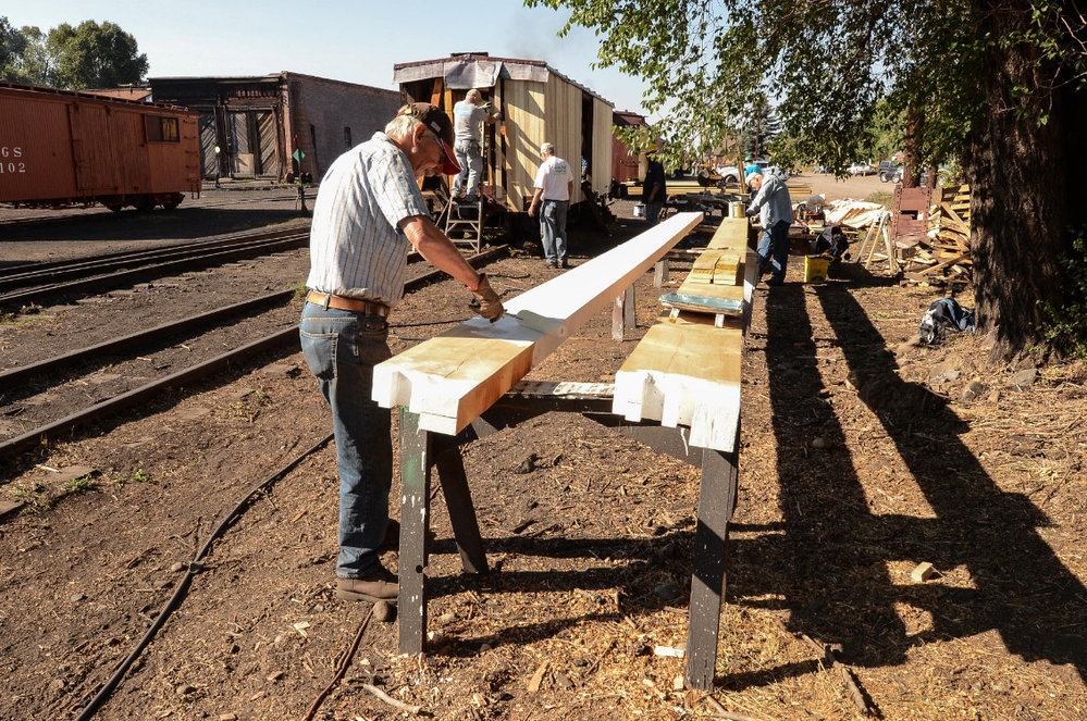 2018-07-28 Painted is going on on the sill beams for the rider gon while work continues behind on the paint car 3638 (2).jpg