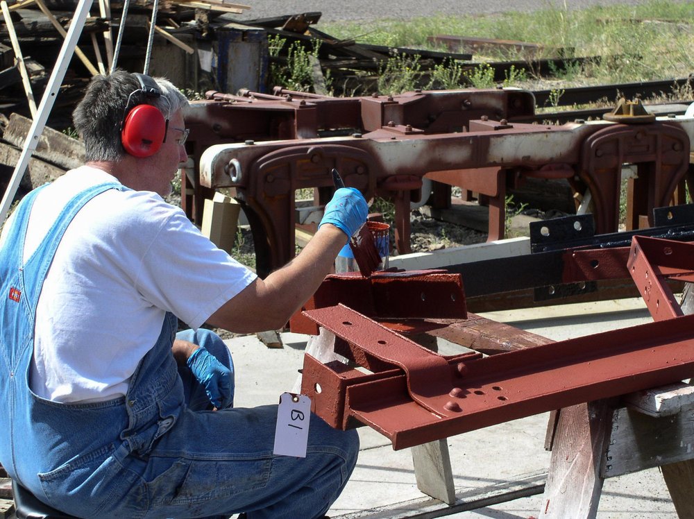 2018-08-03 Outside, one member is priming metal parts.jpg