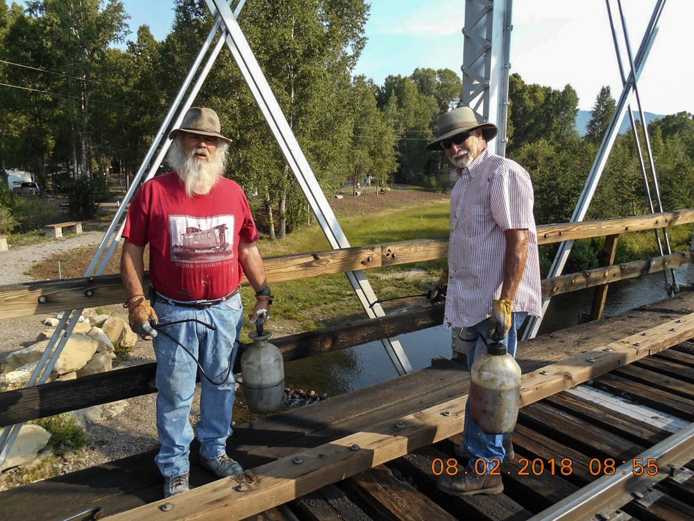 2018-08-02 Replacements done, Brad and his crew spray the bridge with lindseed oil.jpg