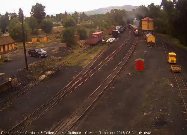 2018-08-21 The 484 passes the tank as the speeder's headlight is seen behind the train.jpg