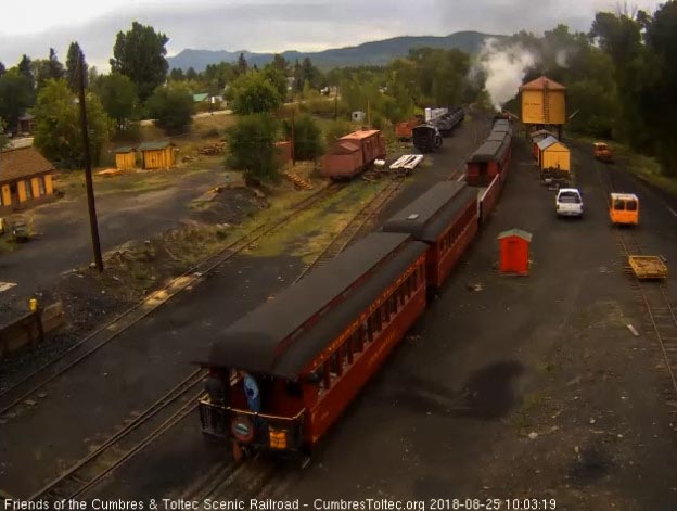 2018-08-25 On the platform of the Colorado is the conductor and a passenger sporting bib overalls.jpg