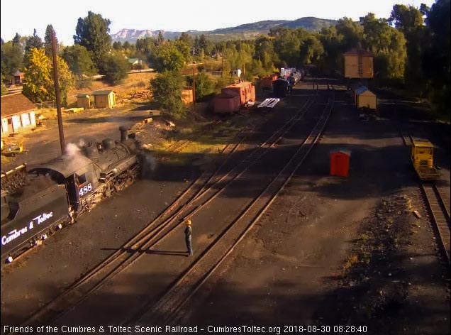 8-08-30 One of the hostlers stands at a safe distance as the other runs the loader putting coal into the tender.jpg