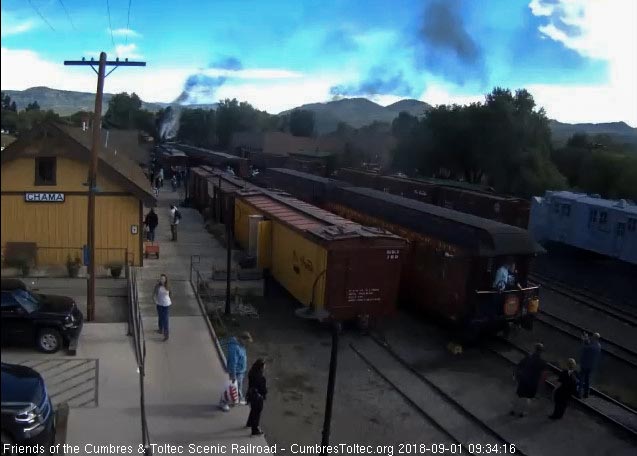 2018-09-01 Three people are standing by the parlor taking the picture of a couple on the platform.jpg