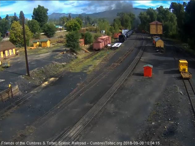 2018-09-06 The smoke is hanging low over the tracks as the last cars round the curve.jpg