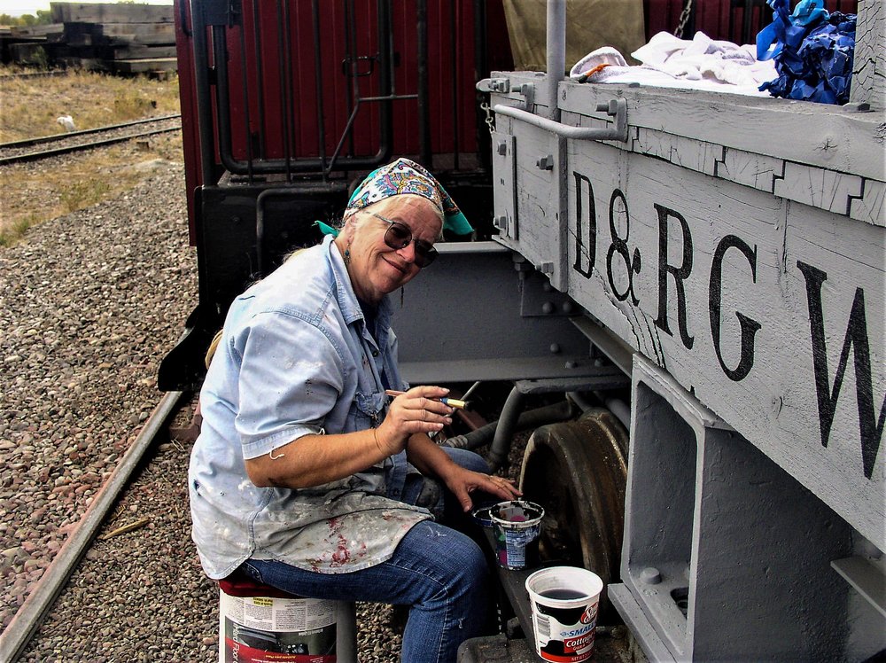 2018-09-25 The camera gets a smile from the lady doing the stenciling.jpg