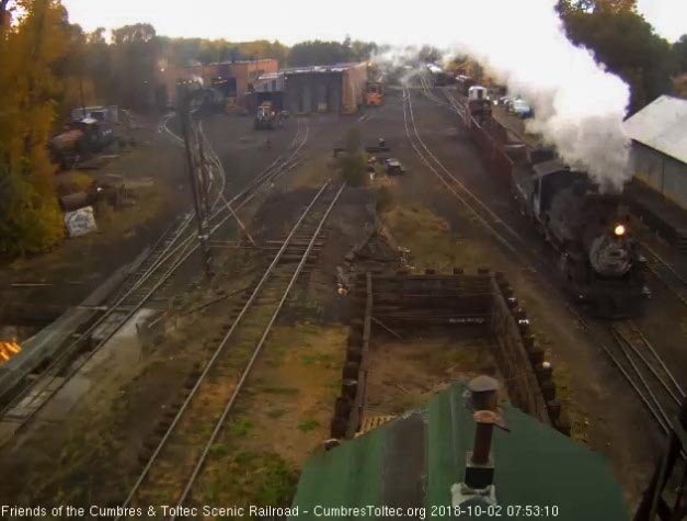 2018-10-02 The short train comes past the woodshop with 2 high sided gons, a rider gon and caboose.jpg
