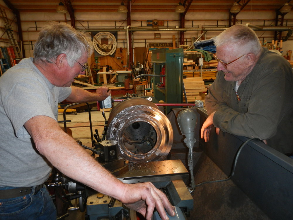 Russ Hanscom builds a jig to expand capabilities of vertical milling machine while Marshall Smith looks on.jpg
