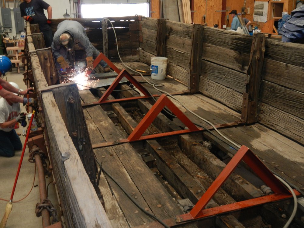Marshall Smith welds the final A frame support in place on Drop Bottom Gondola 768..jpg