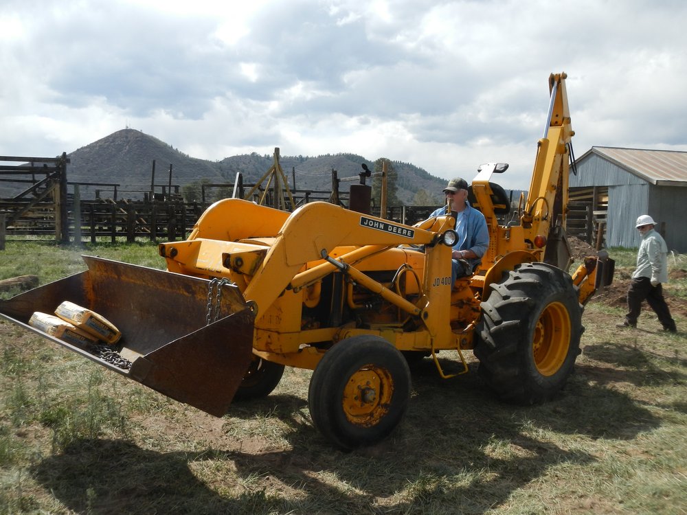 Team Leader Len Jones at the helm of the John Deere and his pick-up team of George Trevor and Ron Leira.jpg