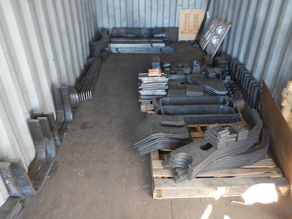 An entire container will contain only truck parts - both metal and wood.  To make best use of space members are installing shelving across the end of the container.  A.jpg