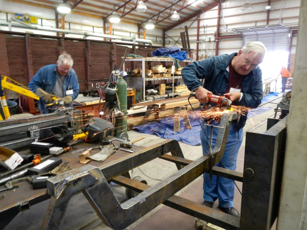 John Weiss, Foreground, and Russ Hanscom background are grinding welds on truck elements.jpg