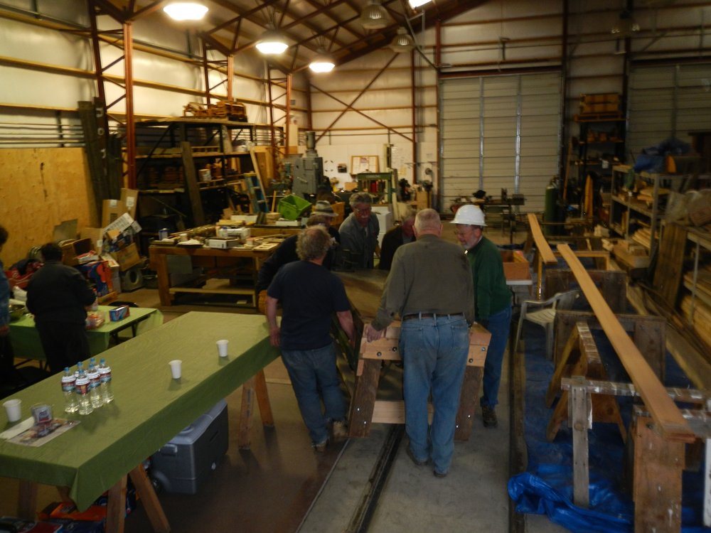 Making Room!  A gang is moving a very heavy work table to make some room in our crowded CRF.  7 guys to move this work bench.   Malcolm Mackey builds stout!.jpg