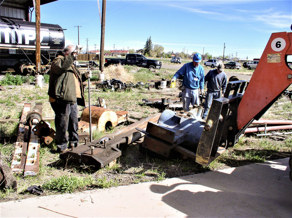 Crew working on moving parts of the wheel press.jpg