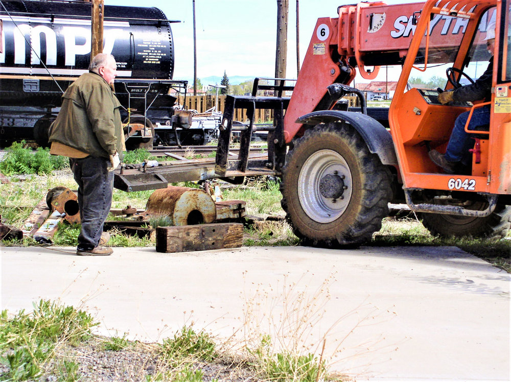 Crew working on moving parts of the wheel press 2.jpg