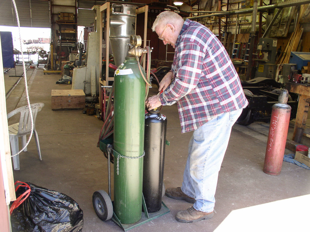 Looks like he is setting up an oxy-acetline torch.jpg