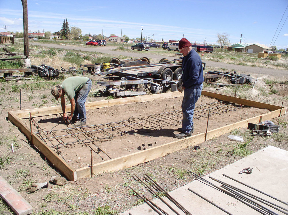 Putting rebar into the pad before the concrete is poured.jpg