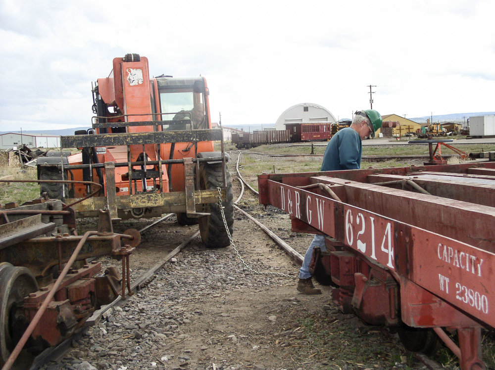 Attaching a chain to the steel frame flat car in order to move it.jpg