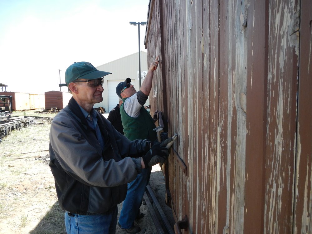 Fred Pitroff  near camera and Greg Coit continue paint prep on Concession Potty car..jpg