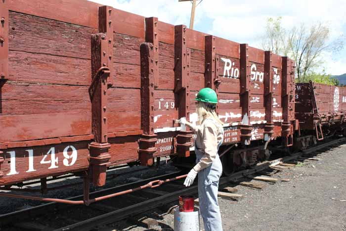 6.19.19 A member of the paint crew touches up high sided gon 1149 (1 of 1).jpg