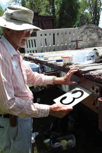 6.20.19 A member of the stenciling crew gets ready to paint a number on a flat car (1 of 1).jpg